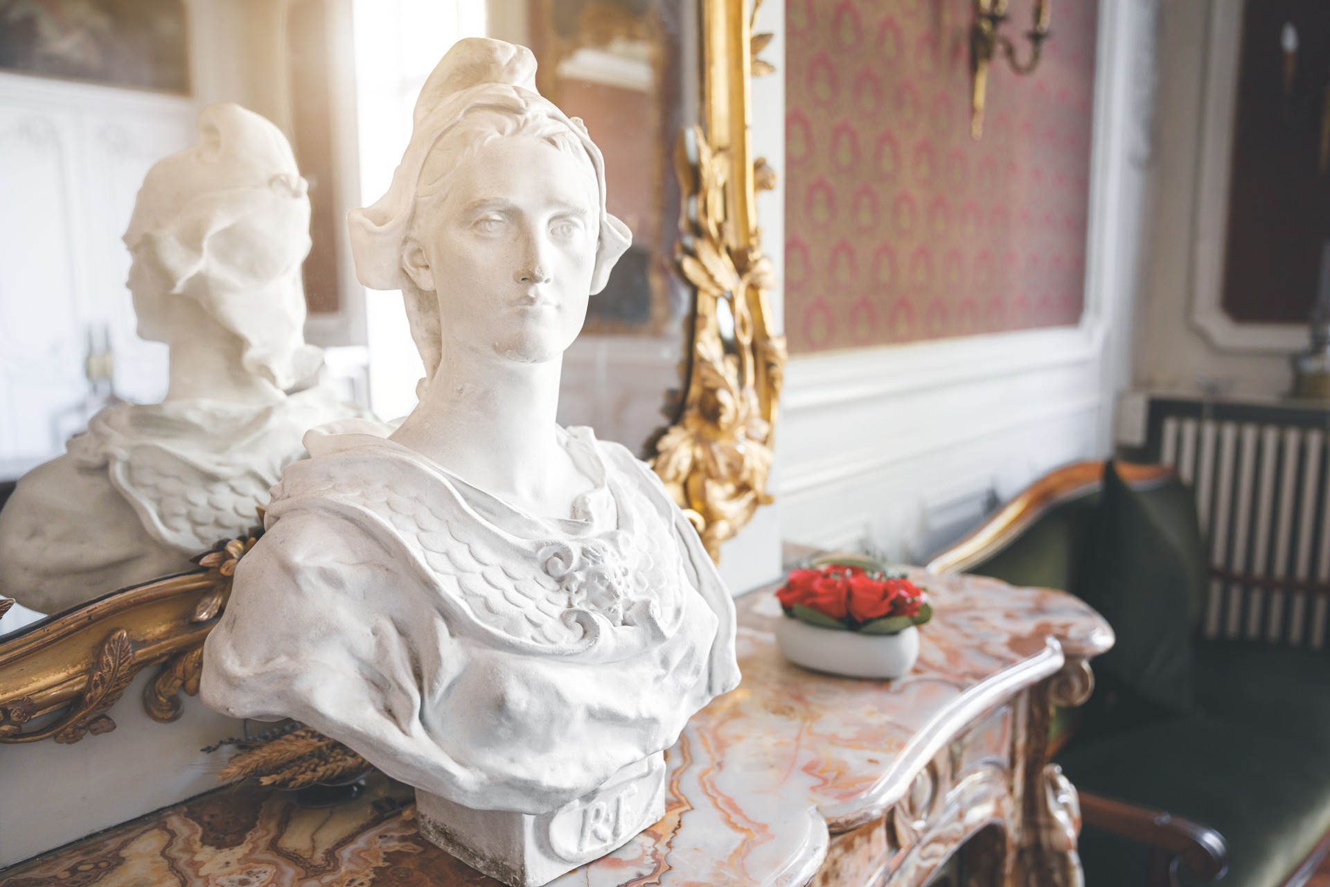 Marble bust of French symbol Marianne placed on beautiful ancient fireplace in Ambronay town hall
